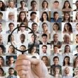 A hand holding a magnifying glass over a collage of diverse faces, symbolizing people search websites and the pursuit of personal information. A hand holding a magnifying glass over a collage of diverse faces, symbolizing people search websites and the pursuit of personal information.