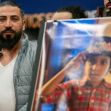 A man stands beside a poster of his deceased son, Wadea Al-Fayoume, during a press conference regarding a wrongful death lawsuit following the boy's murder. A man stands beside a poster of his deceased son, Wadea Al-Fayoume, during a press conference regarding a wrongful death lawsuit following the boy's murder.