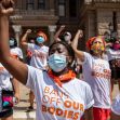 A group of protesters wearing masks and shirts with the slogan "BANS OFF OUR BODIES" raise their fists in a demonstration against the Texas abortion law. A group of protesters wearing masks and shirts with the slogan "BANS OFF OUR BODIES" raise their fists in a demonstration against the Texas abortion law.