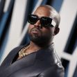 Kanye West wearing sunglasses and a stylish outfit at an event. Kanye West wearing sunglasses and a stylish outfit at an event.