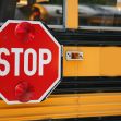 Stop sign on a school bus with red lights activated. Stop sign on a school bus with red lights activated.