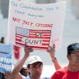 A group of protesters holding signs advocating for the counting of all residents in the U.S. census, emphasizing the importance of including non-citizens. A group of protesters holding signs advocating for the counting of all residents in the U.S. census, emphasizing the importance of including non-citizens.