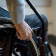 A close-up of a hand gripping the wheel of a wheelchair, symbolizing the impact of paralysis. A close-up of a hand gripping the wheel of a wheelchair, symbolizing the impact of paralysis.
