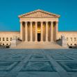 Image of the United States Supreme Court building with a clear blue sky in the background. Image of the United States Supreme Court building with a clear blue sky in the background.
