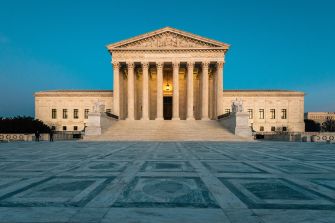 Image of the United States Supreme Court building with a clear blue sky in the background.