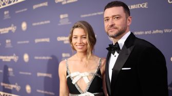 Justin Timberlake and a woman posing at an event, both dressed in formal attire.