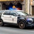 A Los Angeles police vehicle with its lights on, driving through the city. A Los Angeles police vehicle with its lights on, driving through the city.