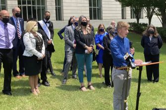 A group of supporters gathering during a press conference regarding the ruling on gender-affirming care for youths in Arkansas.
