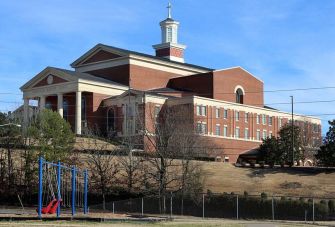 Image of Immanuel Baptist Church in Little Rock, Arkansas, alongside a playground area.