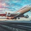 An airplane taking off from an airport runway with a colorful sky in the background. An airplane taking off from an airport runway with a colorful sky in the background.