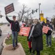 Protesters holding signs related to a lawsuit against Linn-Mar School District's gender identity policy. Protesters holding signs related to a lawsuit against Linn-Mar School District's gender identity policy.