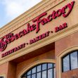 Signage of The Cheesecake Factory restaurant, featuring its name prominently along with the terms "Restaurant," "Bakery," and "Bar." Signage of The Cheesecake Factory restaurant, featuring its name prominently along with the terms "Restaurant," "Bakery," and "Bar."