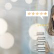 A woman smiling with a digital overlay of customer reviews and ratings, emphasizing the importance of authentic feedback in consumer decision-making. A woman smiling with a digital overlay of customer reviews and ratings, emphasizing the importance of authentic feedback in consumer decision-making.