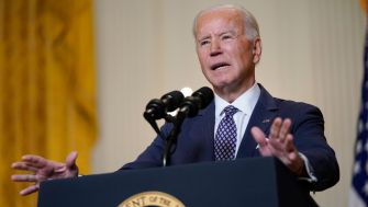 President Biden speaking at a podium, discussing his immigration plan.