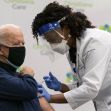 A healthcare professional administering a COVID-19 vaccine to an individual. A healthcare professional administering a COVID-19 vaccine to an individual.