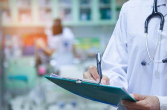 A healthcare professional in a lab coat holding a clipboard while writing notes in a clinical setting.