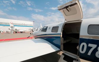 A Piper M600 aircraft with its door open, showcasing the sleek design and interior.