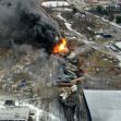 Aerial view of the train derailment site in East Palestine, Ohio, showing dark smoke and fire from the incident. Aerial view of the train derailment site in East Palestine, Ohio, showing dark smoke and fire from the incident.