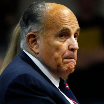 Rudy Giuliani looking serious during a public appearance.
