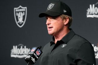 Jon Gruden speaking at a press conference as the head coach of the Las Vegas Raiders.