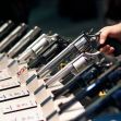 A display of various handguns on a table, with a hand holding one revolver. A display of various handguns on a table, with a hand holding one revolver.