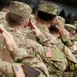 A group of Army veterans in military uniforms saluting. A group of Army veterans in military uniforms saluting.