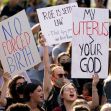 Protesters holding signs expressing their views on abortion rights during a demonstration. Protesters holding signs expressing their views on abortion rights during a demonstration.