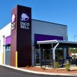 Exterior of a Taco Bell restaurant showcasing its distinctive branding and design. Exterior of a Taco Bell restaurant showcasing its distinctive branding and design.
