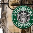 Signage of a Starbucks coffee shop featuring the iconic green and white logo. Signage of a Starbucks coffee shop featuring the iconic green and white logo.