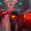 A line of cars with illuminated tail lights in a traffic jam during twilight. A line of cars with illuminated tail lights in a traffic jam during twilight.
