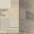 Sign on a building displaying the words "Department of Justice." Sign on a building displaying the words "Department of Justice."