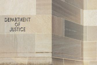 Sign on a building displaying the words "Department of Justice."