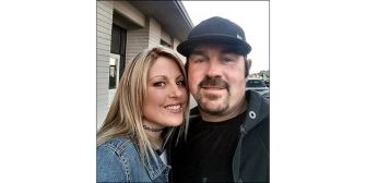 Image of a couple smiling together.