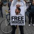 A person holding a sign that reads "FREE MOHSEN" during a protest, advocating for the release of Mohsen Mahdawi. A person holding a sign that reads "FREE MOHSEN" during a protest, advocating for the release of Mohsen Mahdawi.