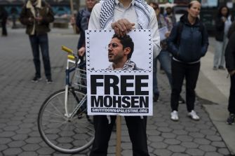 A person holding a sign that reads "FREE MOHSEN" during a protest, advocating for the release of Mohsen Mahdawi.