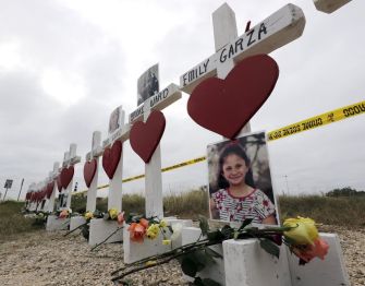 Memorial crosses with photographs and flowers honoring the victims of the Texas church shooting.